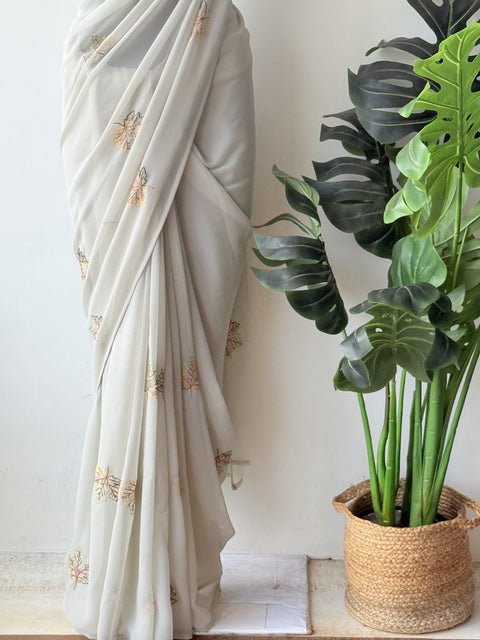 Pastel green maple leaf emb georgette saree